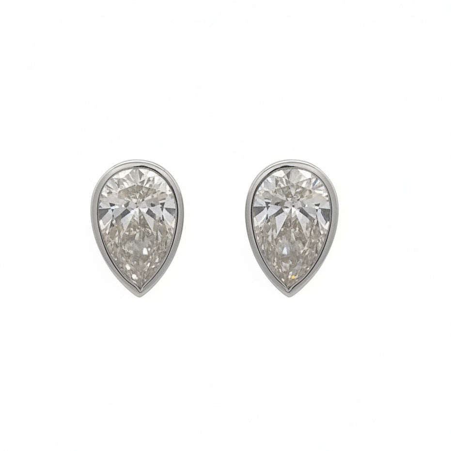 14k white gold and lab bezel-set pear shaped diamonds earrings.